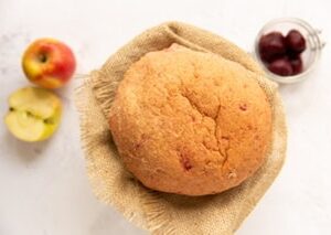 Loaf of beetroot and apple bread on hessian with a apple and pickled beetroot